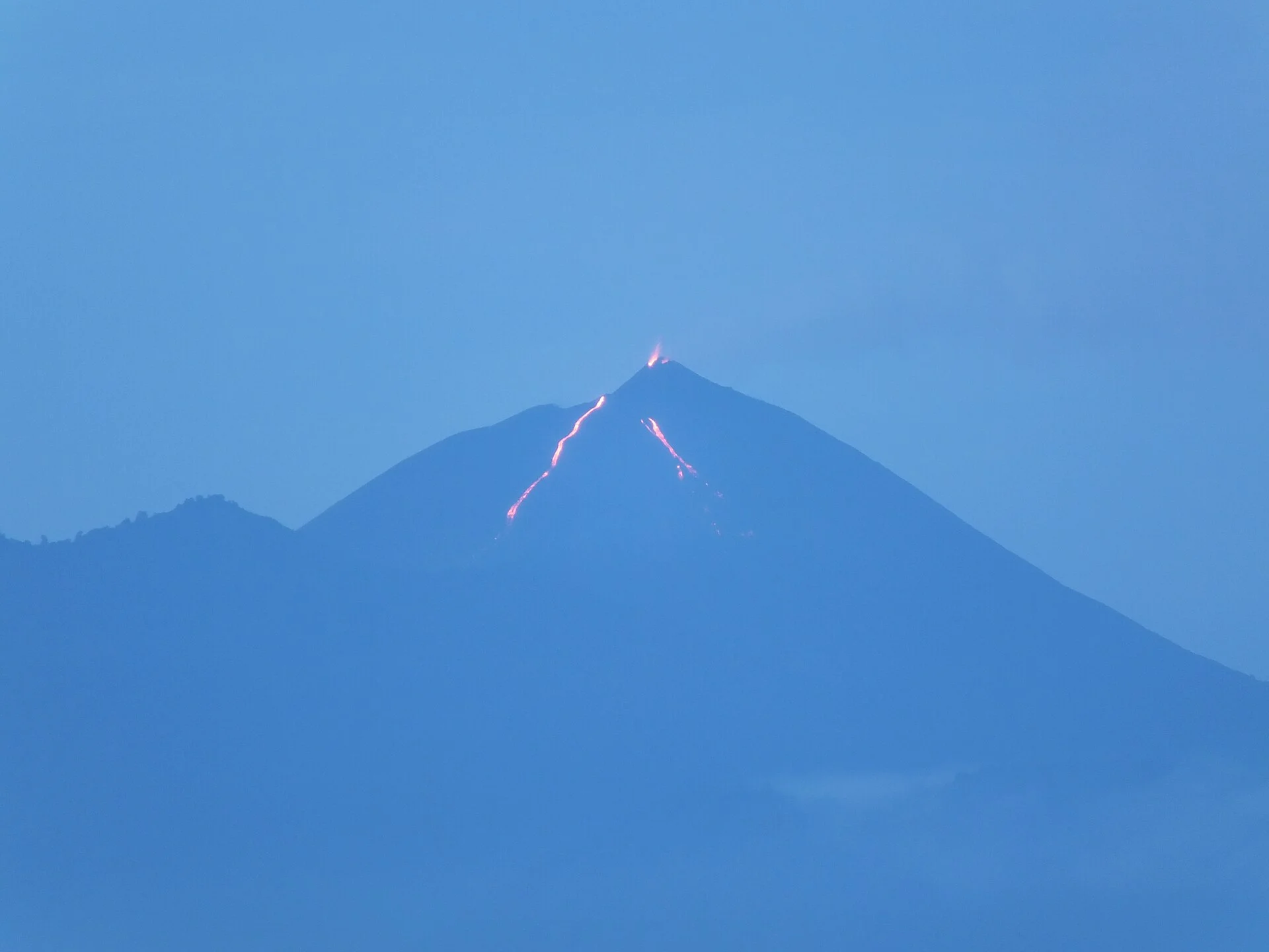 Pacaya seen from Guatemala City at dawn with historical lava activity